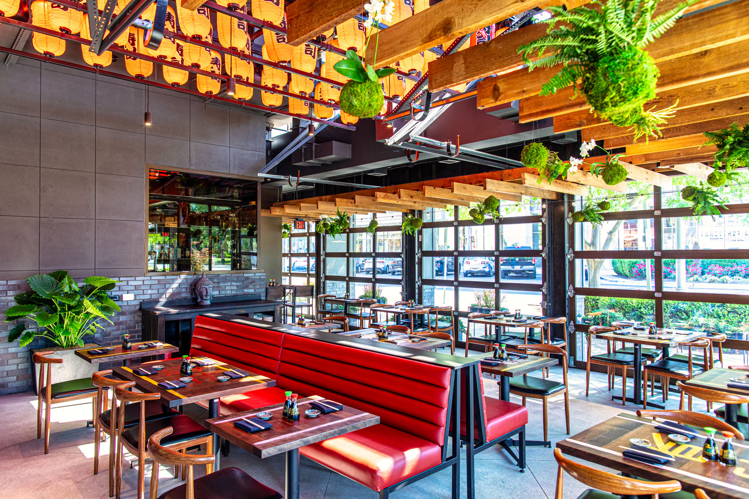 Inside of Blue Sushi Sake Grill restaurant full of vibrant colors and seating. 